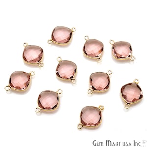 May include: Ten rose quartz gemstone connector charms with gold-plated settings. Each charm features a square-shaped gemstone with a faceted design and two gold loops for attaching to jewelry.