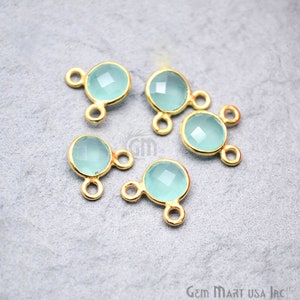 May include: Five gold-toned gemstone connectors with two loops each. The gemstones are round and light blue.