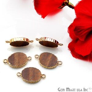 May include: Four gold-toned oval-shaped connector pieces with a wood-like pattern. Each piece has two gold-toned loops on the sides.