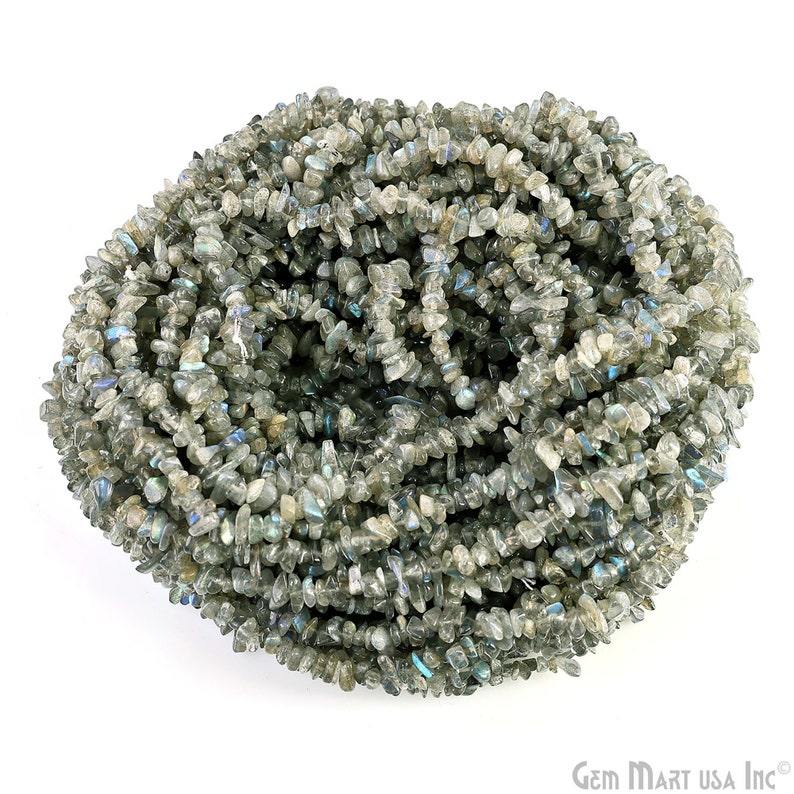 May include: A strand of gray and iridescent labradorite chip beads. The beads are irregular in shape and have a natural, rough texture.