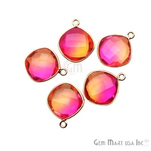 May include: Five gold-toned pendant charms with faceted, square-shaped, pink and orange glass stones. The stones have a gradient colour effect, transitioning from pink to orange.