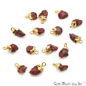 May include: A collection of 14 gold-plated ruby gemstone pendants. Each pendant features a raw, natural ruby stone with a gold-plated bail for easy attachment to jewelry.