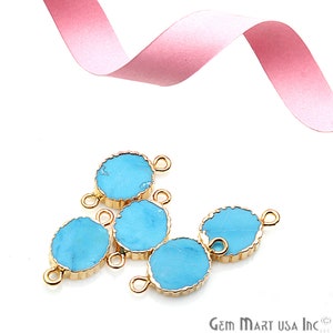 May include: Five turquoise blue gemstone connector charms with gold-toned metal settings and two jump rings on each charm.