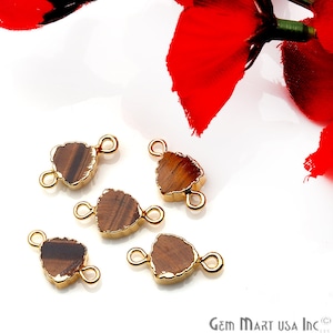 May include: Five gold-toned tiger's eye gemstone connector charms with a triangular shape. Each charm has two jump rings for attaching to jewelry.