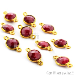 May include: Ten gold-toned gemstone connector charms with red ruby stones. Each charm has two loops for attaching to jewelry.