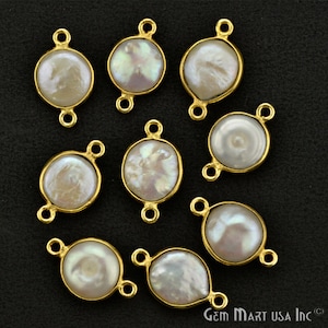 May include: Ten gold-toned round and oval-shaped pearl connectors with two jump rings on each. The pearls are white with a slight iridescent sheen.