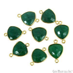 May include: Eight green gemstone triangle pendant charms with gold-tone jump rings. The charms are faceted and have a shiny finish.