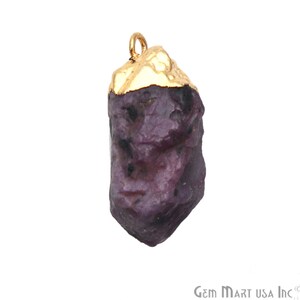May include: A raw purple gemstone pendant with a gold-plated top. The pendant is irregularly shaped and has a rough, natural texture.
