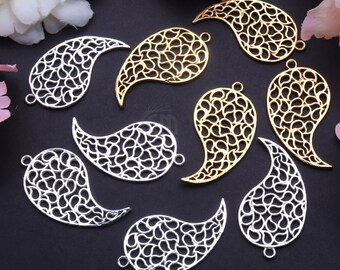 May include: Eight filigree metal pendants in the shape of a teardrop with a paisley design. Four pendants are gold and four are silver.