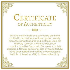 May include: A certificate of authenticity with a gold border and ornate design. The text reads "CERTIFICATE OF AUTHENTICITY". The certificate states that items purchased are hand-crafted in accordance with recognized jewelry manufacturing standards and materials used are ethically sourced. The items exclusively manufactured by Gemmart USA, are accurately described. Natural gemstones sold by GemMartUSA have been tested and verified by Gemological Institute of America (GIA) for their authenticity.