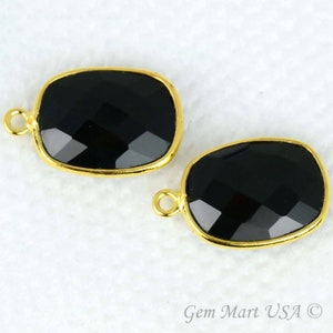 May include: Two black onyx gemstone pendants with gold-toned bezels and jump rings.