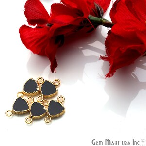 May include: Six black triangle-shaped gemstone connectors with gold-toned metal accents. The connectors have a rough, irregular edge and are perfect for adding a touch of elegance to jewelry projects.
