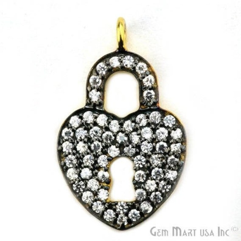 May include: A gold-tone heart-shaped padlock charm with a keyhole and pave-set clear cubic zirconia stones.
