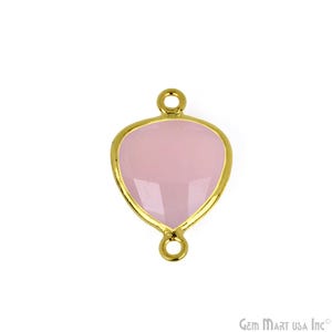 May include: Gold-tone pendant with a pink gemstone in a heart shape. The pendant has two loops on the top and bottom for attaching to a chain or cord.