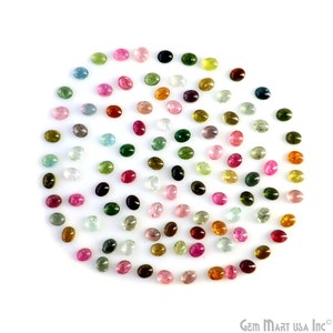 May include: A collection of oval-shaped gemstones in various colors, including pink, green, blue, and red. The gemstones are arranged in a circle on a white background.