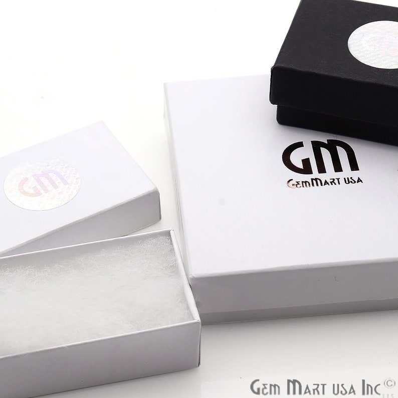 May include: Three white gift boxes with a black and white logo that says "GemMart USA". The smallest box has white filling inside.