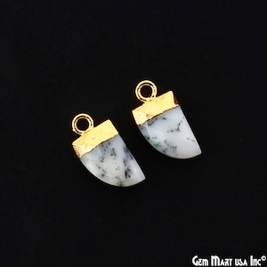 May include: Two white and black dendritic opal tooth-shaped pendants with gold-plated tops and jump rings.