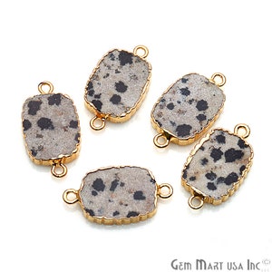 May include: Five gold-toned metal connector charms with a rectangular dalmatian jasper stone. The stone is a light gray with black spots.