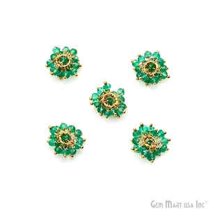 May include: Five green gemstone flower-shaped embellishments with gold wire accents. Each embellishment has a circular center with a gold ring.