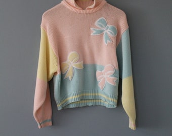 pull pastel à nœuds