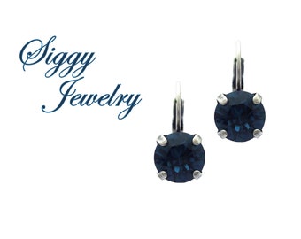 May include: A pair of silver earrings with dark blue round crystal stones.