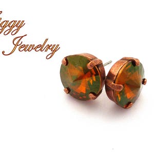 May include: A pair of copper stud earrings with round, faceted, green and orange gemstones.