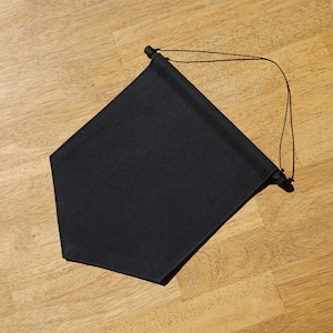 May include: A black fabric pennant banner with a rope loop for hanging.