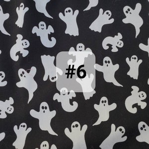 May include: Black fabric with a white ghost pattern. The fabric has the number "#6" printed on it.