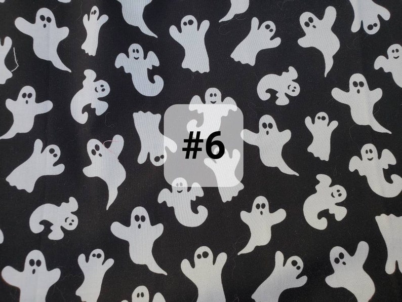May include: Black fabric with a white ghost pattern. The fabric has the number "#6" printed on it.