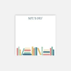 May include: A white note card with the text "Note to Shelf" at the top. The bottom of the card features a row of colorful books.