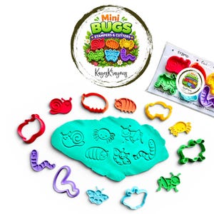 May include: A set of colorful bug-shaped stampers and cutters with a round logo that says "Mini Bugs Stampers & Cutters". The set includes a variety of bug shapes, a container of blue playdough, and a clear plastic bag with bug-shaped stamps.