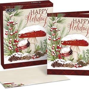 May include: A box of LANG Christmas cards and a card featuring a watercolor illustration of a red mushroom with snow, pine needles, and berries. The words "HAPPY Holidays" are written in elegant script.