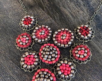 Beaded circle bib necklace in reds and bronze