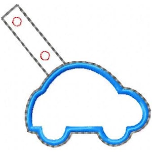 May include: A blue car-shaped key chain with a grey loop and two silver rings.