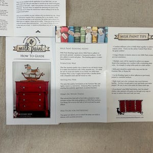 May include: A guide to using milk paint, with tips on bonding agents, waxes, and finishes. The guide includes images of a red painted dresser and a rocking horse.