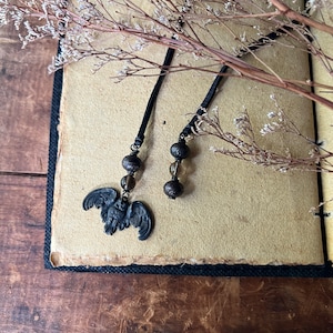 Peut inclure: Deux marque-pages en ruban noir avec des perles de verre brun et un charme de hibou en métal noir.