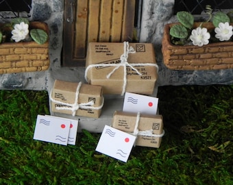 May include: Four miniature cardboard packages tied with twine and decorated with a red stamp. Two white envelopes with a red stamp and a blue wave design are also included.