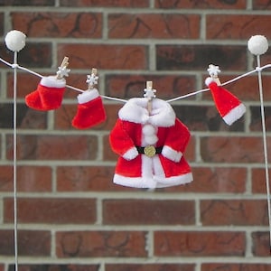 Clothesline made out of pvc plastic water pipes and thick yarn. Hung baby  girl clothes & socks with small clothes pins…