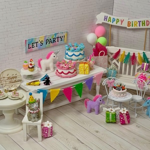 May include: A miniature birthday party scene with cakes, unicorns, and a cat wearing a party hat. The scene includes a banner that says "Happy Birthday" and another that says "Let's Party!" Colorful decorations and gifts are also present.