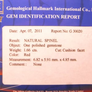 May include: A Gemological Hallmark International Co., Ltd. gem identification report for a 1.66 carat red natural spinel gemstone. The report states the gemstone is a cushion facet cut, measuring 6.82 x 5.91 mm x 4.85 mm. The report date is April 07, 2011, and the report number is G 30020.