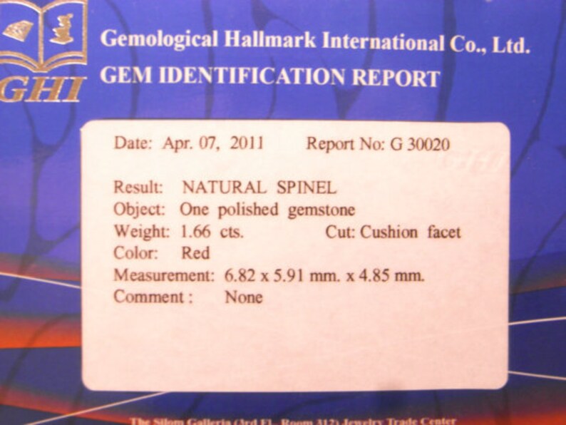 May include: A Gemological Hallmark International Co., Ltd. gem identification report for a 1.66 carat red natural spinel gemstone. The report states the gemstone is a cushion facet cut, measuring 6.82 x 5.91 mm x 4.85 mm. The report date is April 07, 2011, and the report number is G 30020.