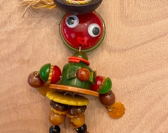 Mexican Fiesta Girl Jan Carlin Figural Cribtoy Style Brooch utilizing vintage Bakelite methods and materials