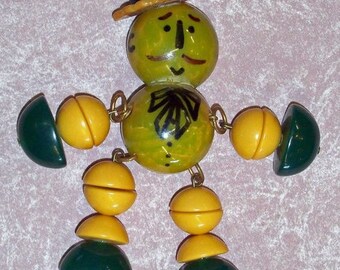 Really Cute Crib toy style Bakelite Man Pin