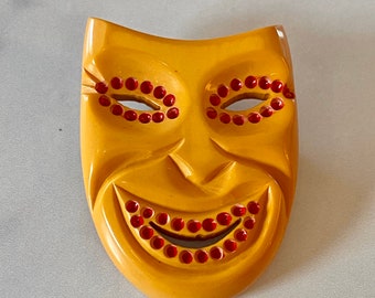 Big Vintage Bakelite Carved Mask Brooch