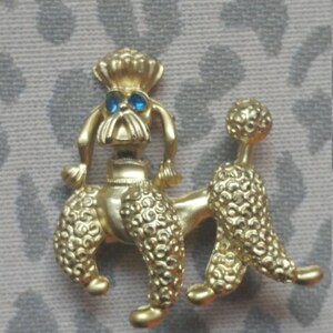 Vintage Goldtone Metal Prancing Blue Eyed Poodle Brooch