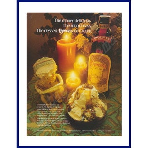 May include: A vintage print advertisement for Kahlua liqueur featuring a bottle of Kahlua, a bowl of ice cream with chocolate sauce, and lit candles. The text reads "The dinner delicious. The mood easy. The dessert Kahlua and ice cream."