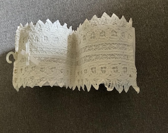Battenburg lace toilet roll holder.