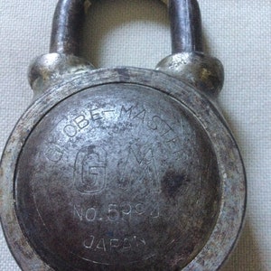 May include: A silver Globe Master padlock with the text "Globe Master" and "GM" in a circle, "No. 59C4", and "JAPAN" inscribed on the front.