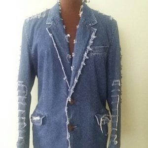 May include: A blue denim jacket with frayed edges and a button closure.