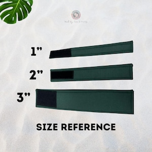 May include: Size reference for green fabric straps with black velcro closures. The straps are 1 inch, 2 inches, and 3 inches long. "Size Reference" is written below the straps.